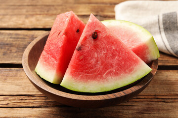 Delicious fresh watermelon slices on wooden table, closeup