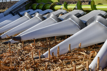 Detail of corn combine header on harvested field. 