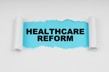In the middle of a white sheet in space on a blue background the inscription - HEALTHCARE REFORM