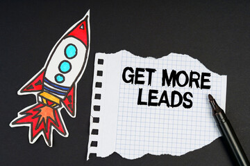 On a black background, a rocket, a marker and paper with the inscription - GET MORE LEADS