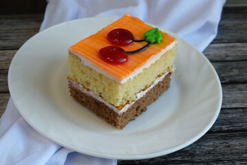 A piece of sponge cake. Sweet and delicious multi-layered dessert.