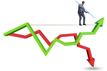 Businessman balancing on tightrope on line chart