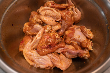 Marinating chicken wings in a metal grill bowl