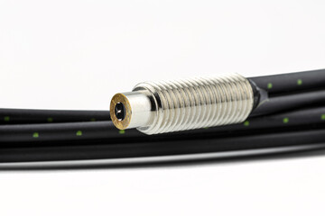 Macro photo of a fiber optic cable with two inserts, isolated on a white background, terminated...