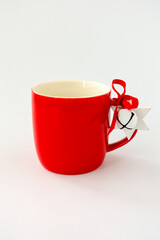 Closeup of an Empty Red Mug with Homemade Christmas Decoration isolated on White