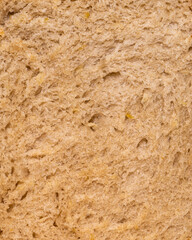 The texture of hot bread from a homemade bread machine. A slice of fresh bread from a bread machine