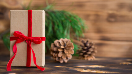 Christmas or New Year gift in craft box with red velvet ribbon