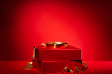 Red podium of gift boxes golden circle, decor Red background
