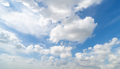 Obraz premium Clear blue sky with white fluffy clouds at noon. Day time. Abstract nature landscape background.