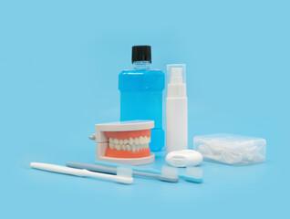 A set of tooth cleaning aid objects for mouth isolated on blue. Brushing and flossing. Dentistry. Dental health. Hygiene.