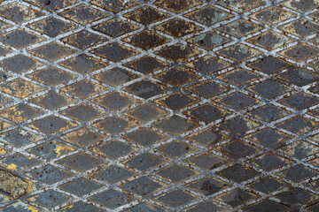 Close-up of old dirty corrugated metal sheet. There are traces of old paint, scratches and rust....