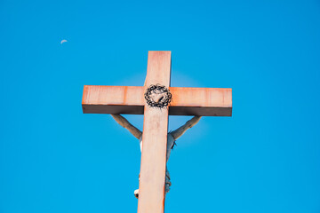 christian cross with Jesus on the back, the moon in the sky in the background
