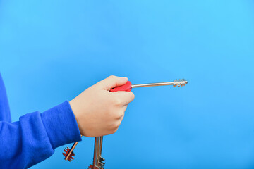 The key to the front door of an apartment and a private house in the hand of a man on a blue...