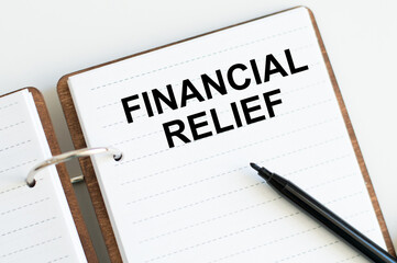 Financial Relief text in notepad on white background