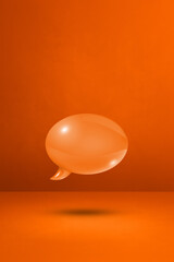 Orange speech bubble on concrete wall vertical background