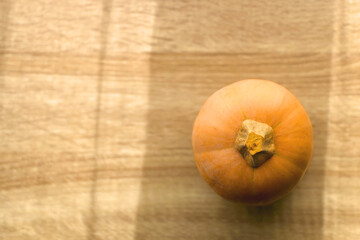Butternut squash on the table, illuminated by sunlight. Top view.