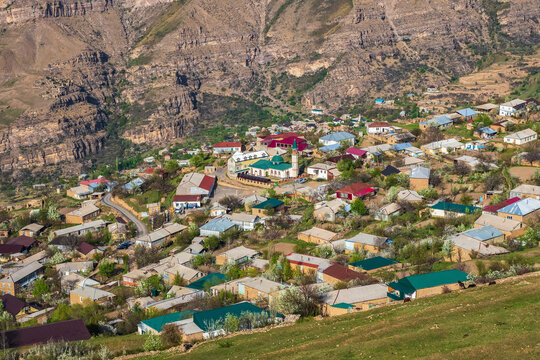 Modern city at the foot of the mountain. Mosque in the center of a mountain village. Landscape and countryside of cityscape in Goor. Dagestan.
