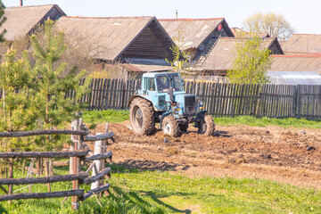 tractor handles field in the spring for planting