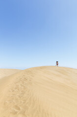 girls walking in dunes