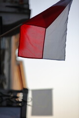 Flag of Poland hangs on building wall 