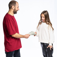 dad gives his daughter money in the studio. a man in a burgundy-red T-shirt, a girl in a white sweatshirt. isolated white background