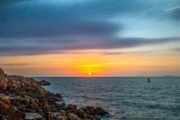 Sunrise over the Atlantic Ocean is seen from the rocky coast of Bass Harbor Head in Acadia National park on Mt. Desert Island in Down East Maine.