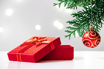 Red gift box and Christmas tree on white background. New Year concept.