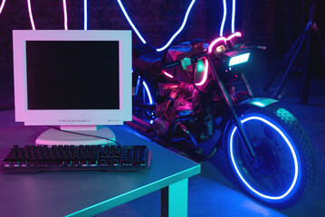 Blank screen computer monitor with copy space on the foreground of neon lights motorbike. Concept of sci fi motorbike development.