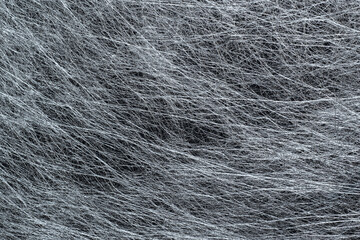 A sheet of silver decorative interlining (non-woven fabric) with visible fibers for background