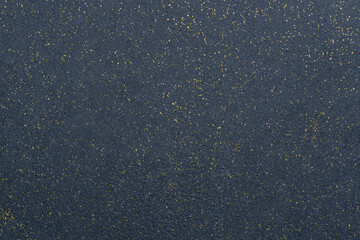 A sheet of navy blue decorative interlining with golden glitter dots. Non-woven fabric as a...