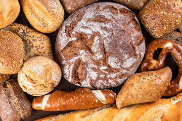 different types of freshly baked bread, baguette, pretzel, etc ... top view, close-up