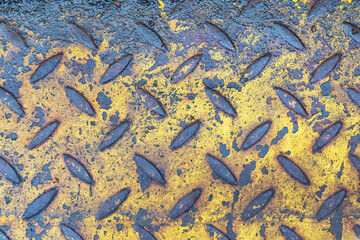Fragment of wet corrugated steel sheet, yellow. There is a lot of dirt, rust and damage on the...
