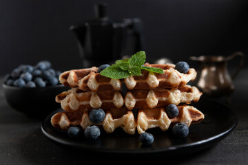 Сroffle, trendy crispy korean baked goods, top view on dark background, selective focus