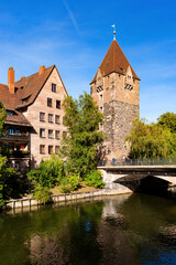 Fototapeta na wymiar Schuldturm tower and bridge on a sunny day in Nuremberg, Germany