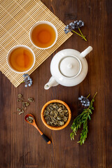 Tea drinking with white teapot and black tea in two cups