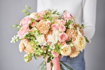 Beautiful bouquet of mixed flowers in woman hand. Floral shop concept . Beautiful fresh cut bouquet. Flowers delivery