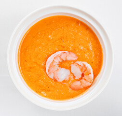 Bowl of cream soup with pumpkin with shrimp. Restaurant menu