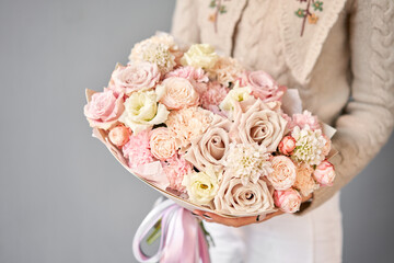 Beautiful bouquet of mixed flowers in woman hand. Floral shop concept . Beautiful fresh cut bouquet. Flowers delivery