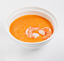 Bowl of cream soup with pumpkin with shrimp. Restaurant menu