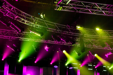 Light systems with colored spotlights mounted on metal structures in a concert hall or television studio