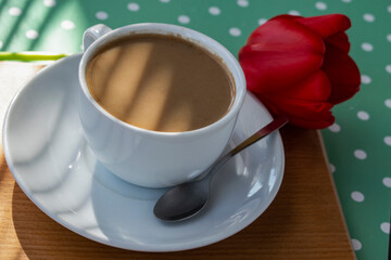 coffee in a white сup with a falling shadow
