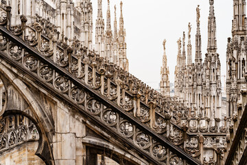 High spires with sculptures of the Duomo. Milan, Italy