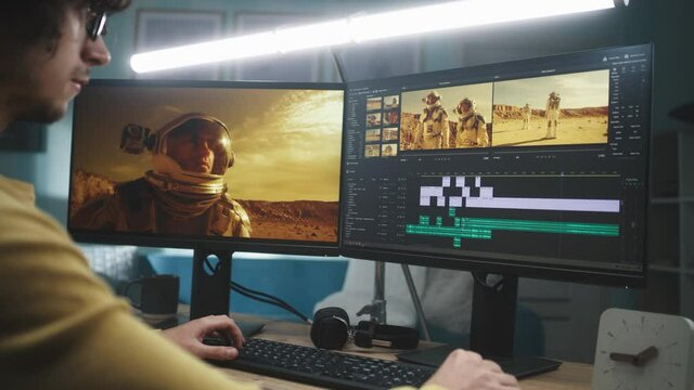 Focused man editing astronaut video