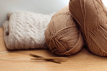 Beige knitting yarn. Handmade knitted products. Hobby, needlework concept.