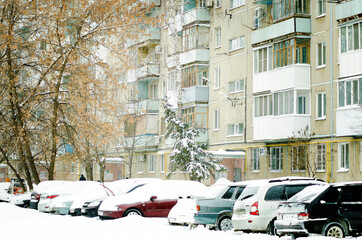 Saratov, Russia- February 11, 2021: Parked cars near a residential building on a winter day.