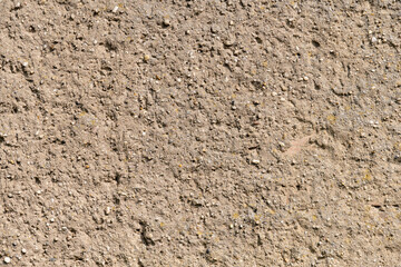 Wall plaster background texture. Abstract backdrop out of concrete and little stones. Brown wall of a building in Germany. Weathered surface of a house with a natural structure.