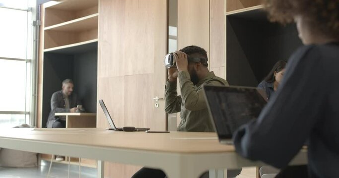 Engineer working with virtual reality headset in creative office