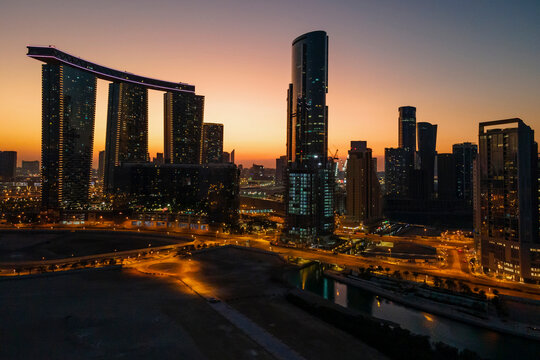 Enchanting Sunset In Al Reem Island In Abu Dhabi. Aerial View Of Silhouetted Modern Skyscrapers.