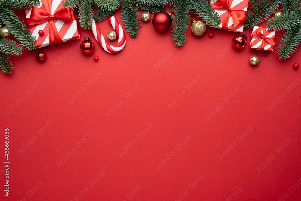 Wall mural red christmas background with fir ornaments and holiday gifts
