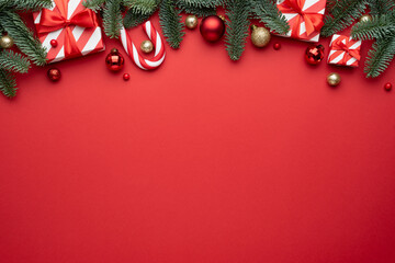 Red Christmas background with fir ornaments and holiday gifts - Powered by Adobe